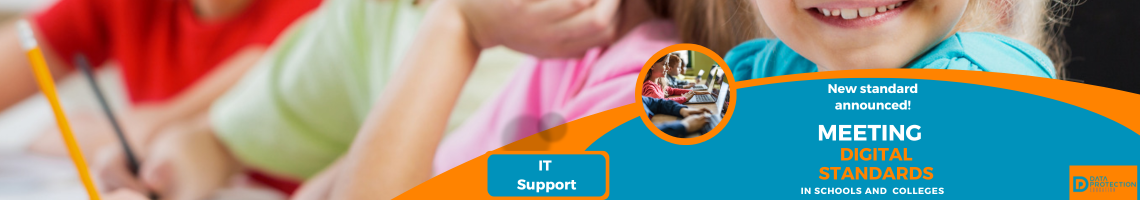  A promotional image for new digital standards in education.  The top half shows four primary school-age children sitting at a desk, looking down and focusing on work. The child closest to the camera on the right is smiling.  The bottom half has an orange and blue graphic overlay that reads: "New standard announced! MEETING DIGITAL STANDARDS IN SCHOOLS AND COLLEGES." In the bottom left corner is a circle image showing students working on laptops. The text "IT Support" is written in a yellow box below the circle. In the bottom right corner is a logo for the "DATA PROTECTION EDUCATION" initiative.